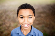 headshot of a smiling boy child 