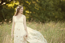 Bride standing in a meadow