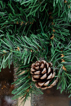 pine cone on an artificial Christmas tree