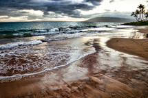 tide washing onto a beach in Hawaii 