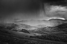 rain showers falling on a mountainside 