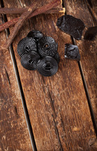 licorice, roots, pure blocks and candy on wooden table