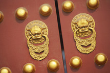 Forbidden Palace main gate doors with dragon handles and brass studs