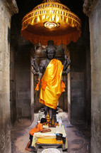 Buddhist statue, altar & small boy. 