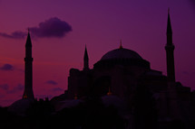 silhouette of a mosque under a purple sky