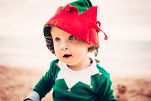 toddler in an Christmas elf costume 