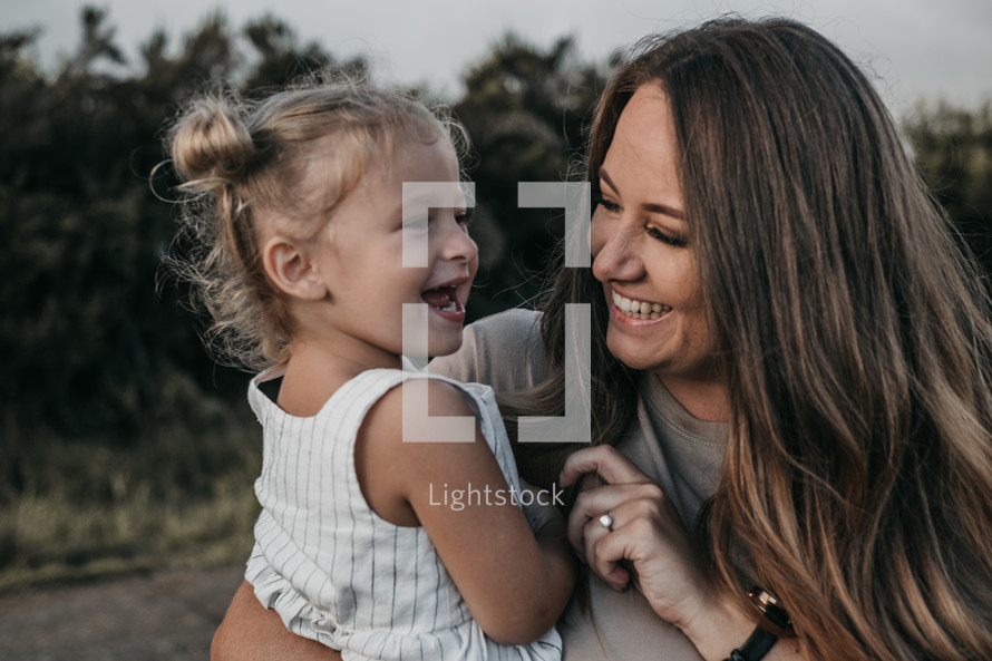 Woman smiling at happy toddler