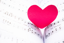 red paper heart on music 