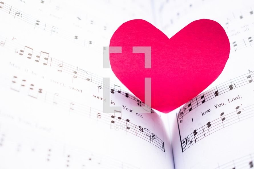 red paper heart on music 