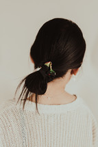 Woman with black hair tied in a bun