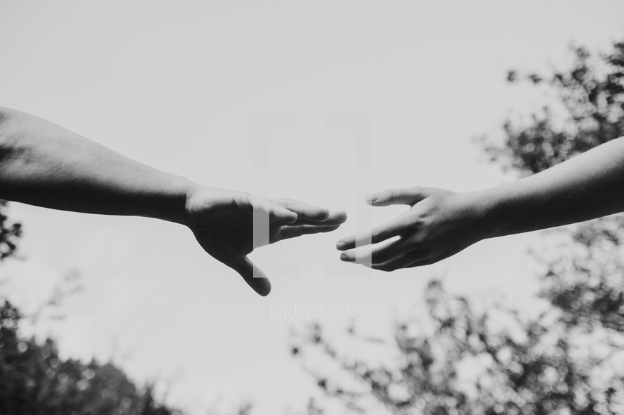 hands reaching towards each other 
