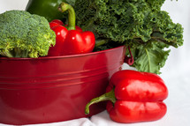 red and green vegetables in a bucket 