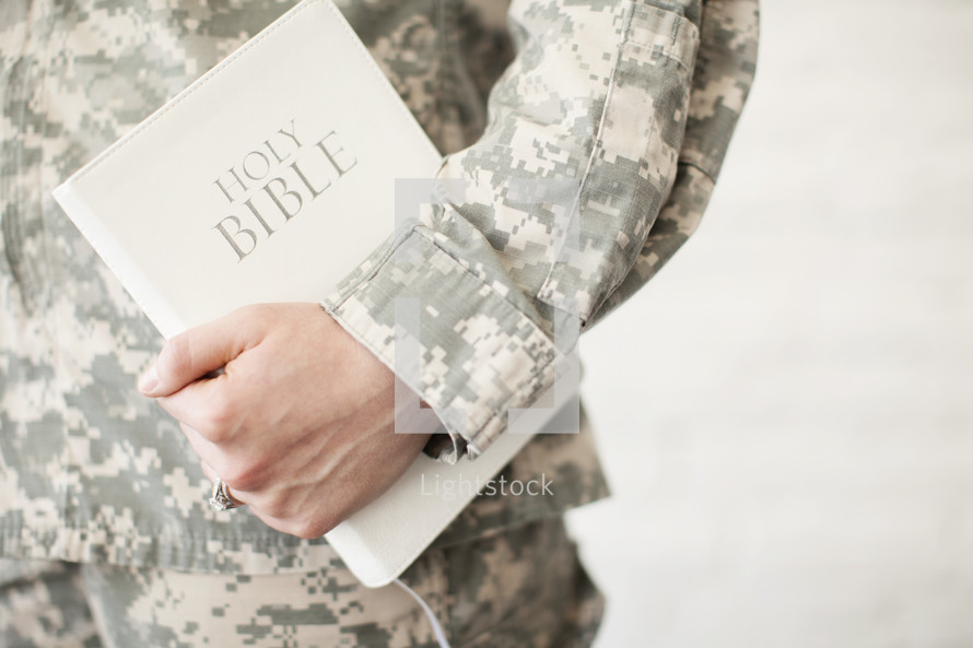 soldier holding a Holy Bible 