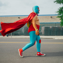 man walking down the street in a super hero costume