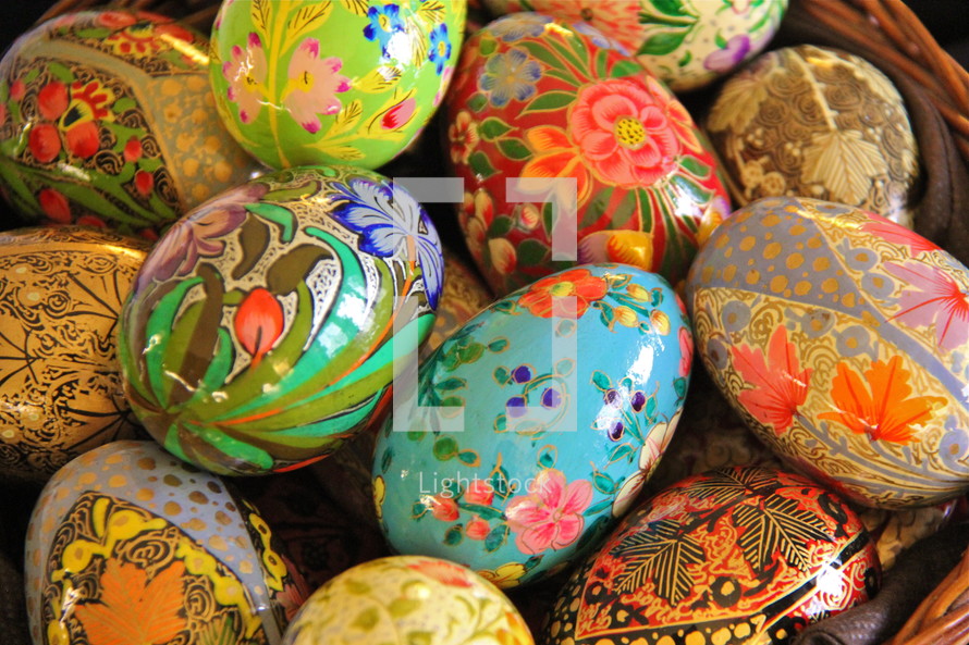 Decorative hand made wooden painted easter eggs in a basket