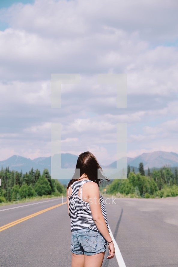 woman standing on a road 