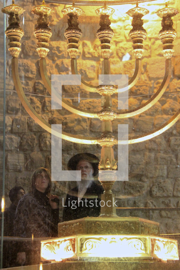 Observers viewing a seven-lamp Menorah at the Western Wall.