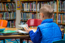 boy reading in a library