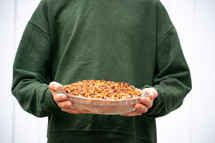 man holding a casserole dish 
