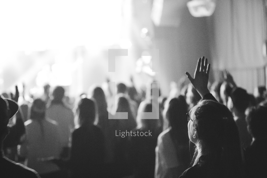 People worshipping Jesus with hands high during worship.