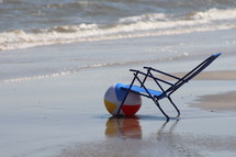 Chair on the shore with beach ball