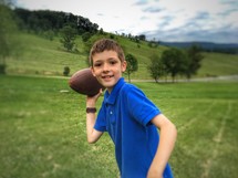 a boy throwing a football 