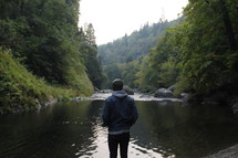 a man standing at the edge of a river 