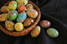 Hand made decorative wooden Easter Eggs in a basket.