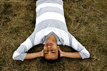 A man relaxing lying in the grass 
