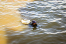man swimming in a lake 