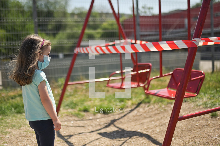 Alone Girl and Children's Swings Wrapped With Signal Tape