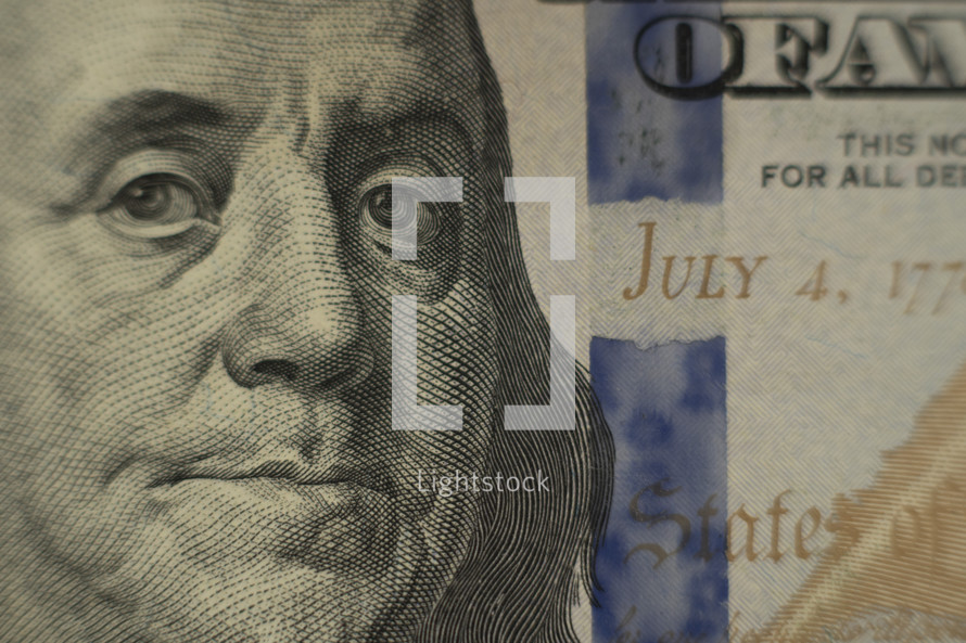 Close up of Benjamin Franklin on a $100 bill