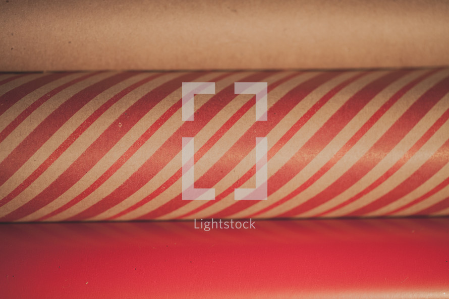 Close up of three rolls of Christmas wrapping paper