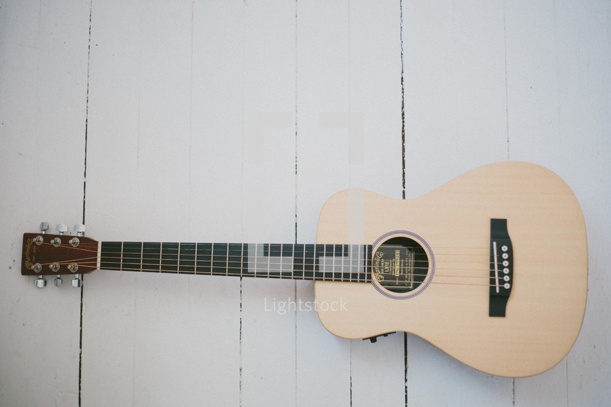 acoustic guitar on a wood floor 