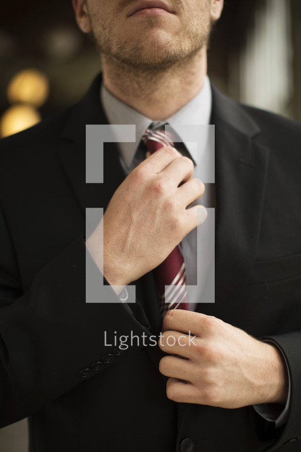 businessman adjusting his tie 