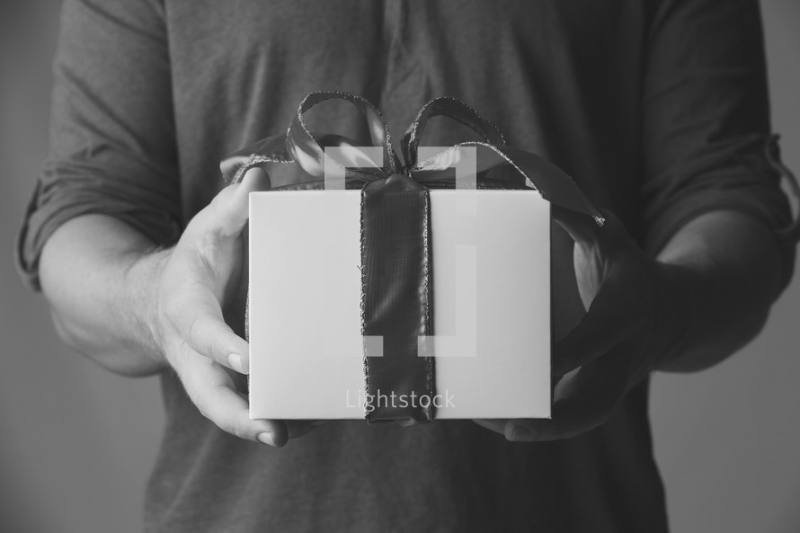 man handing a gift. black and white