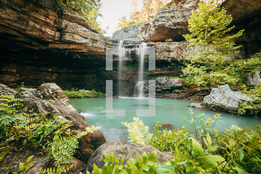 A secluded waterfall cascading into a beautiful pool