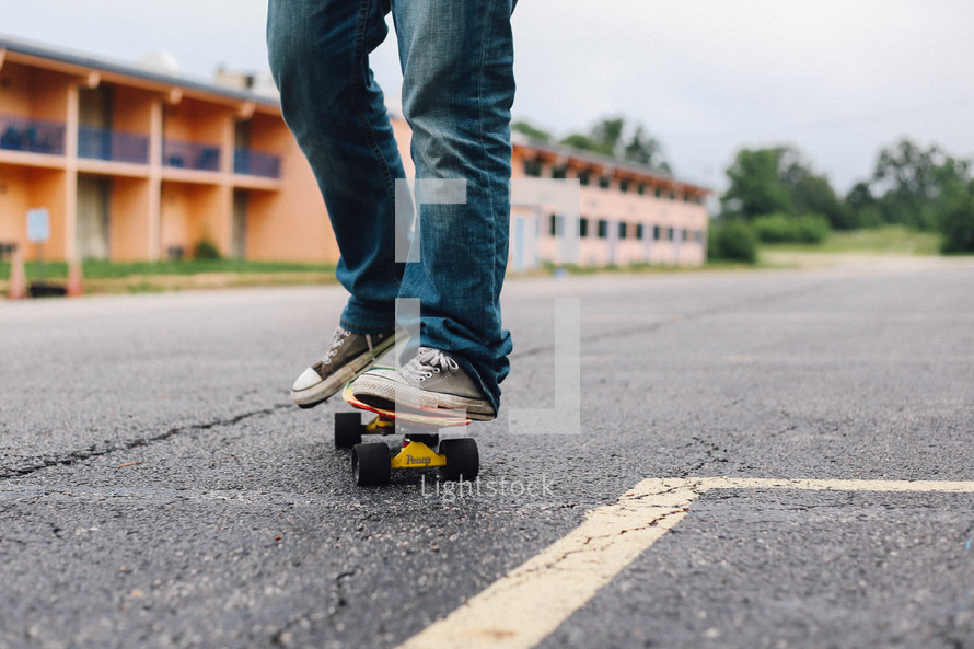 feet of a young man on a skateboard 