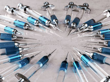 A large group of needles used for a vaccine in a circle