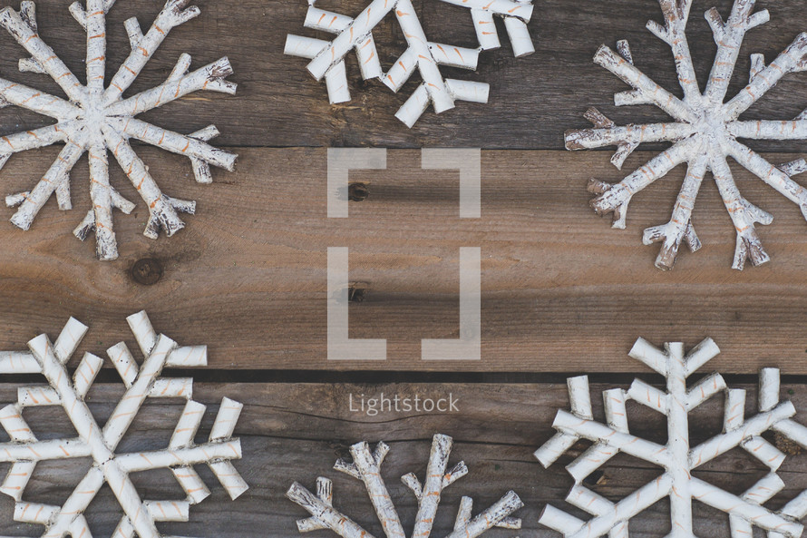 snowflake boarder on a wood background 
