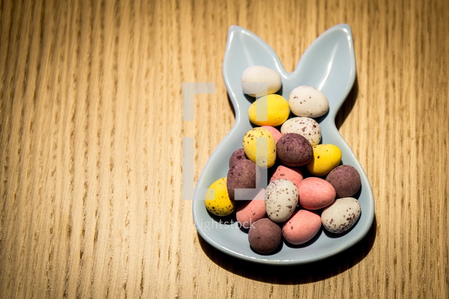 Mini chocolate easter eggs on a bunny shaped bowl