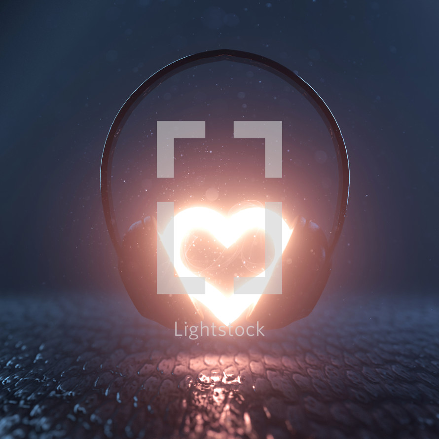A bright glowing heart in the middle of a pair of headphones
