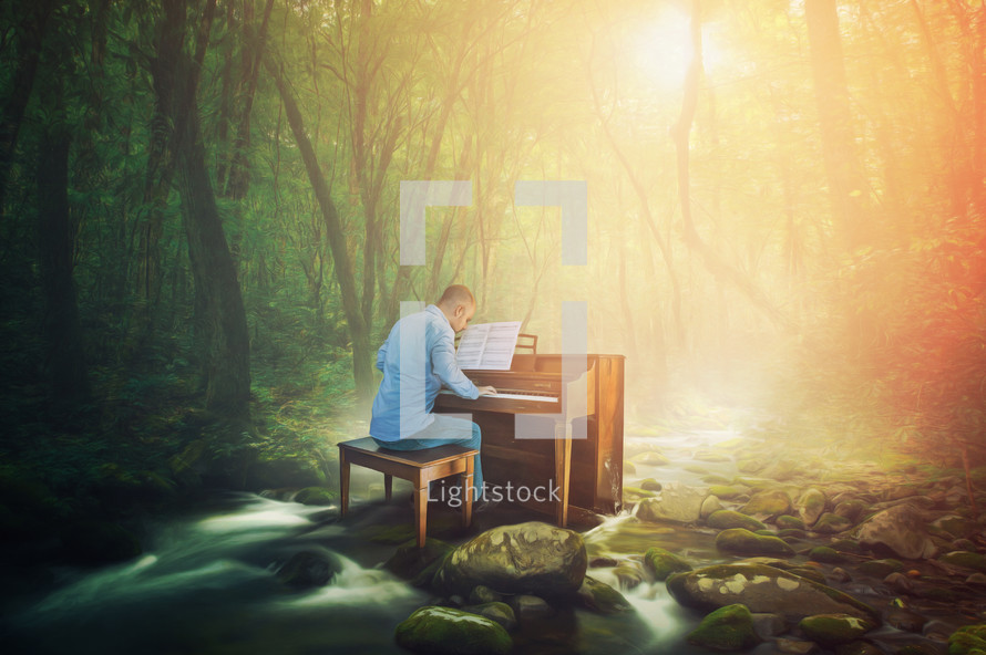 A man is playing a piano in the middle of a forest