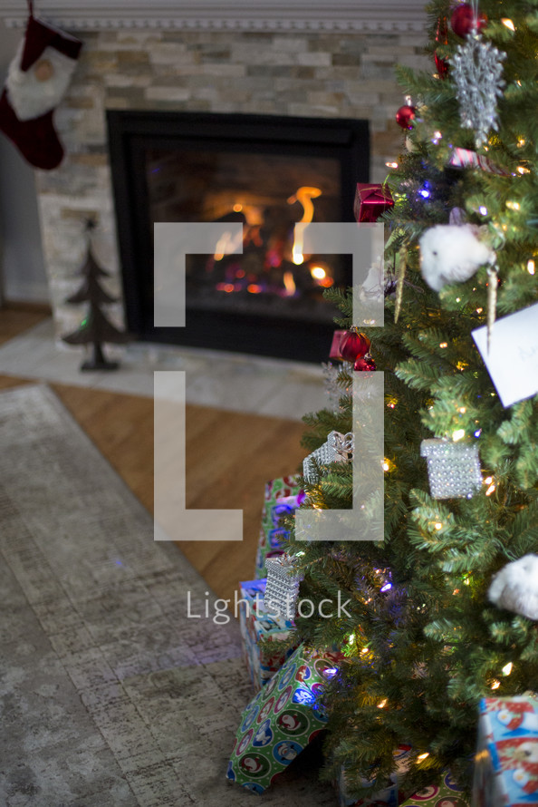 presents under a Christmas tree and fireplace 