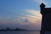 Havana bay at sunset. Turret of Castle Morro protecting the entrance to the harbor.