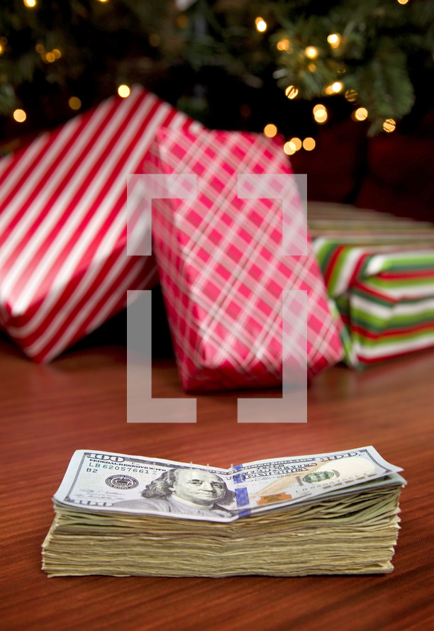 cash in front of a Christmas tree 