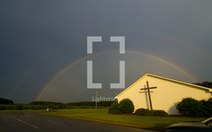 a double rainbow over a church 