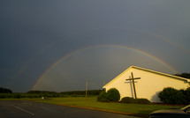 a double rainbow over a church 