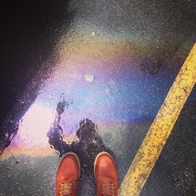 feet and a reflection in a puddle 