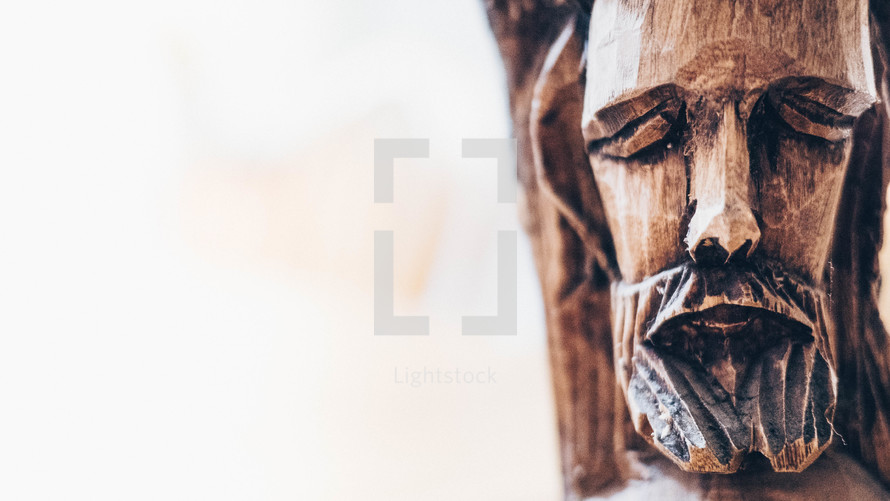 wooden carving of the face of Christ 